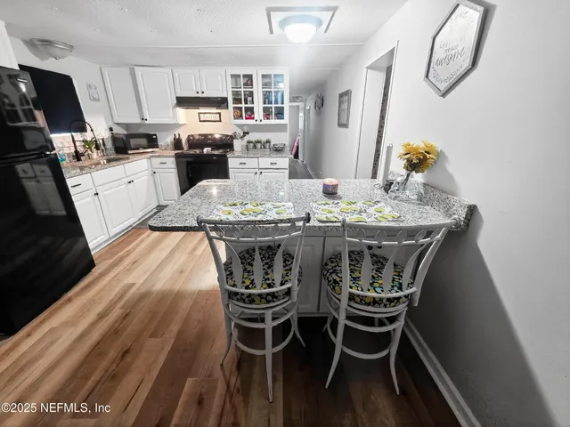 a dining room with furniture and wooden floor