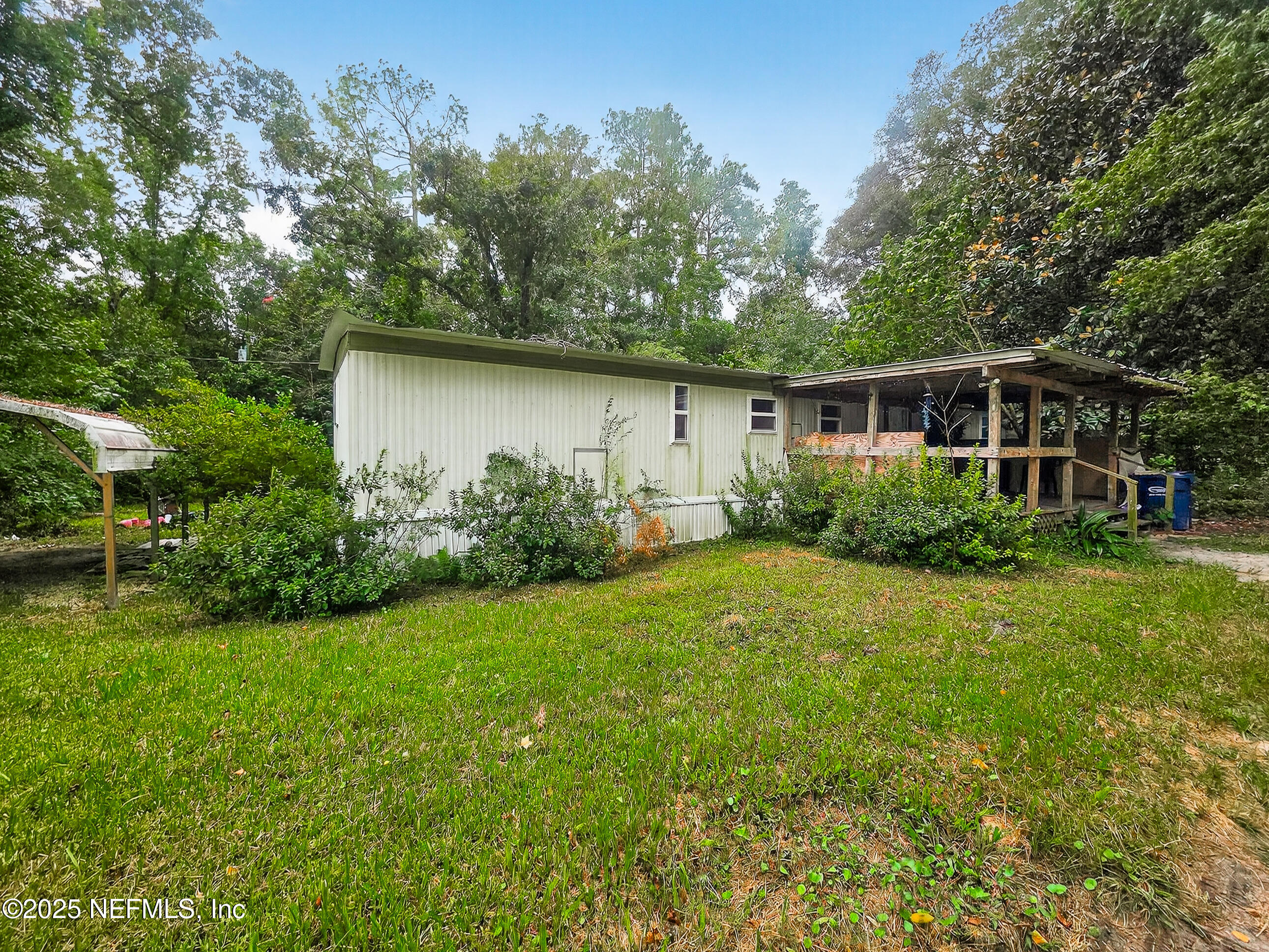 9332 Cedar Road Macclenny, FL 32063 - Photo 22 of 35 a backyard of a house with plants and large trees