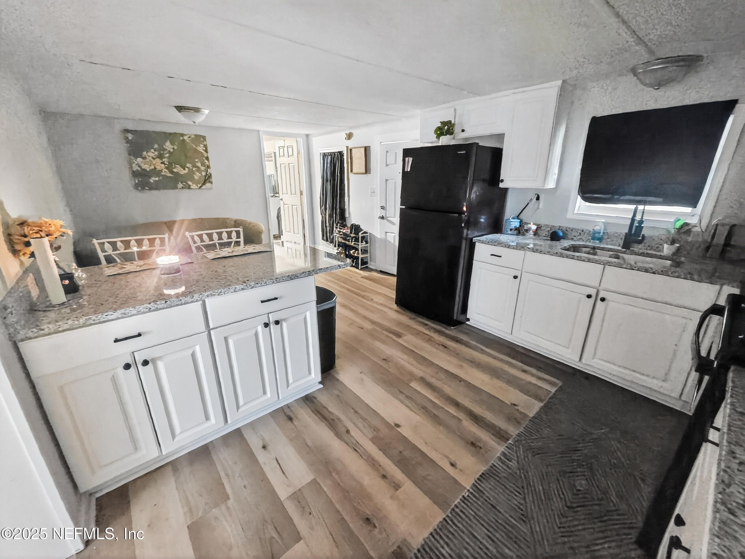 9332 Cedar Road Macclenny, FL 32063 - Photo 3 of 35 a kitchen with white cabinets and stainless steel appliances
