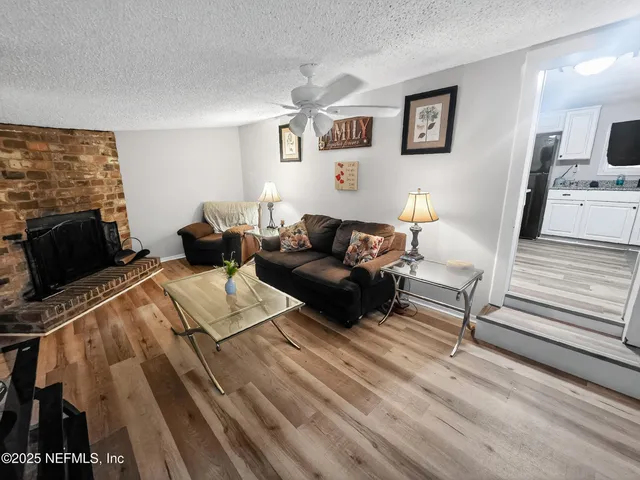 a living room with furniture and a fireplace