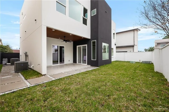 a view of a house with backyard and porch