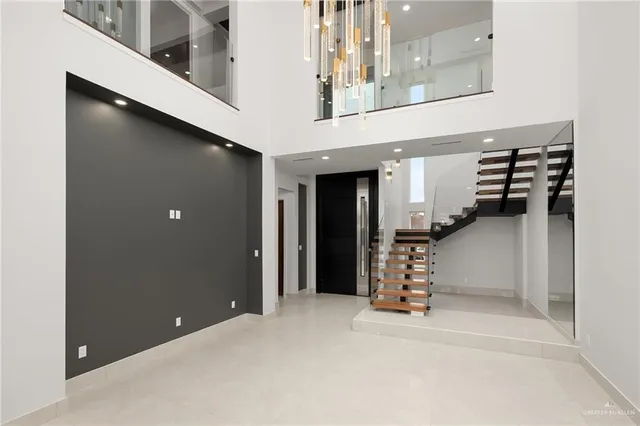 a view of a hallway with a stairs and furniture