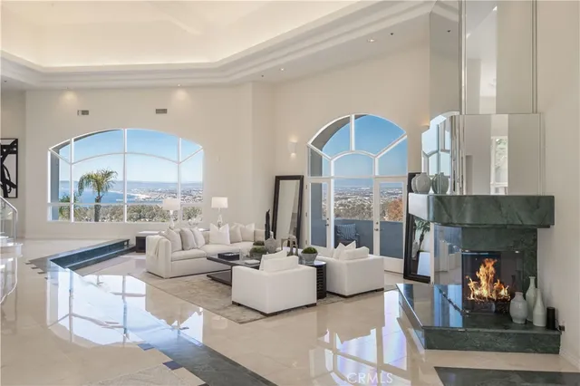 a living room with fireplace furniture and a large window