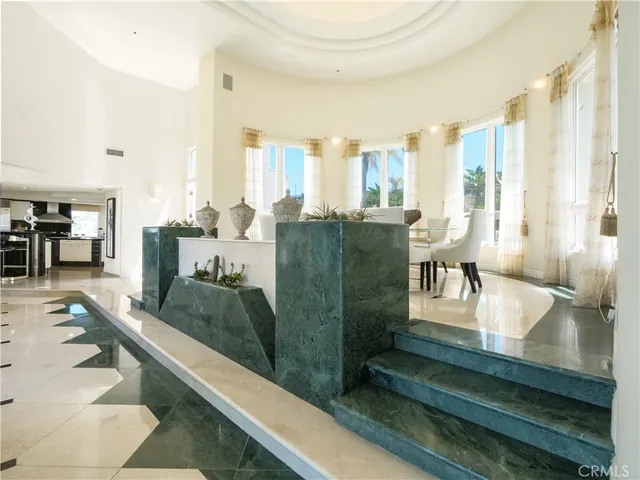 a kitchen with stainless steel appliances kitchen island granite countertop a refrigerator and a sink