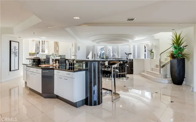 a kitchen with stainless steel appliances a table and chairs in it