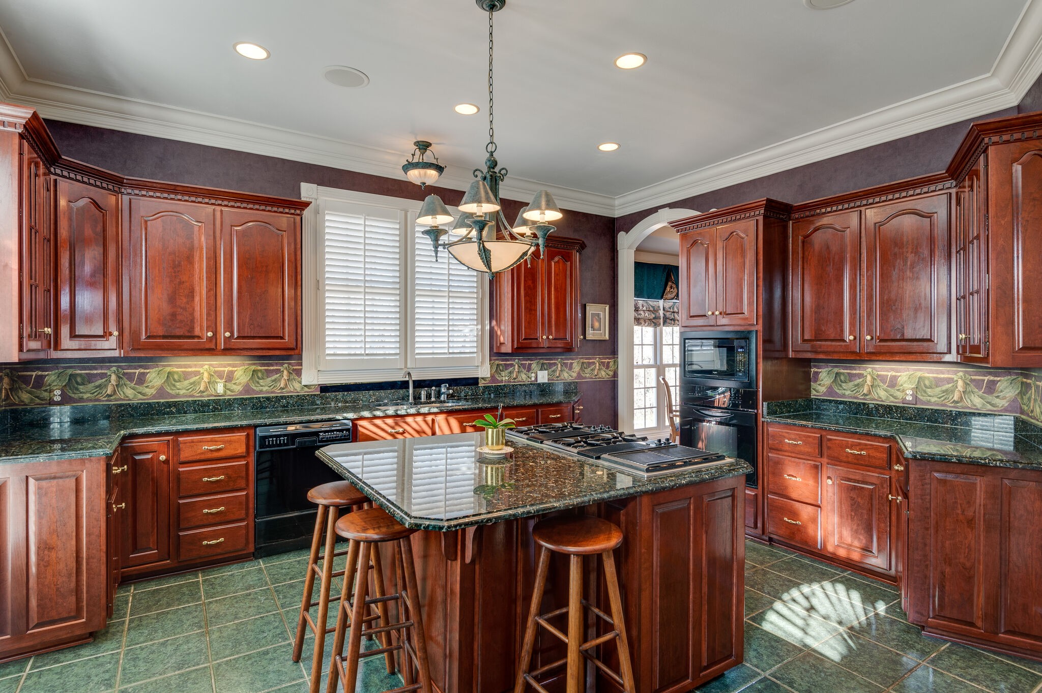 2295 Gideon Road Greenbrier, TN 37073 - Photo 17 of 48 a kitchen with kitchen island granite countertop a sink counter top space appliances and cabinets