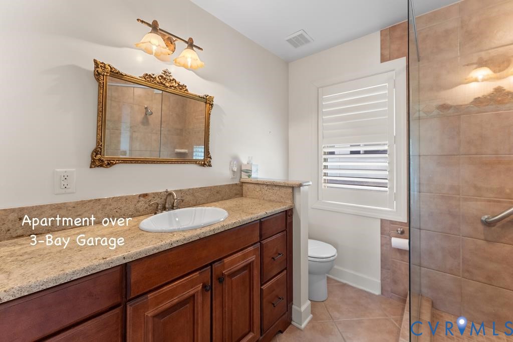 2414 Windmill Point Road White Stone, VA 22578 - Photo 51 of 72 a bathroom with a granite countertop sink toilet and mirror
