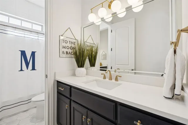 a bathroom with a toilet a sink and a mirror