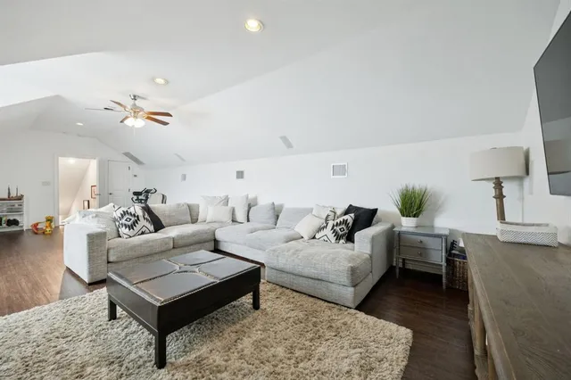 a living room with furniture a fireplace and a floor to ceiling window