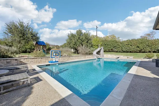 a view of green field with house in the background