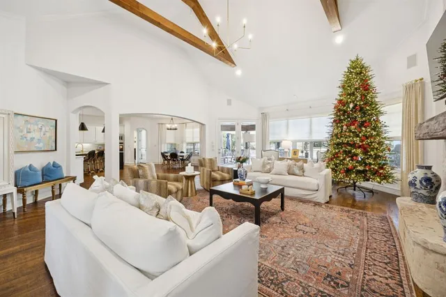 a living room with furniture and a christmas tree