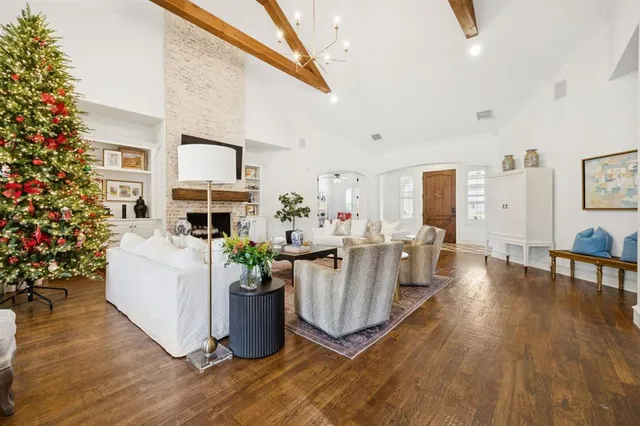 a living room with furniture a fireplace and a potted plant