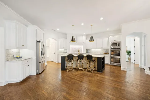 a large kitchen with a table and chairs