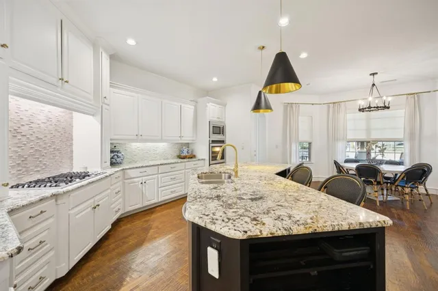 a kitchen with sink and refrigerator