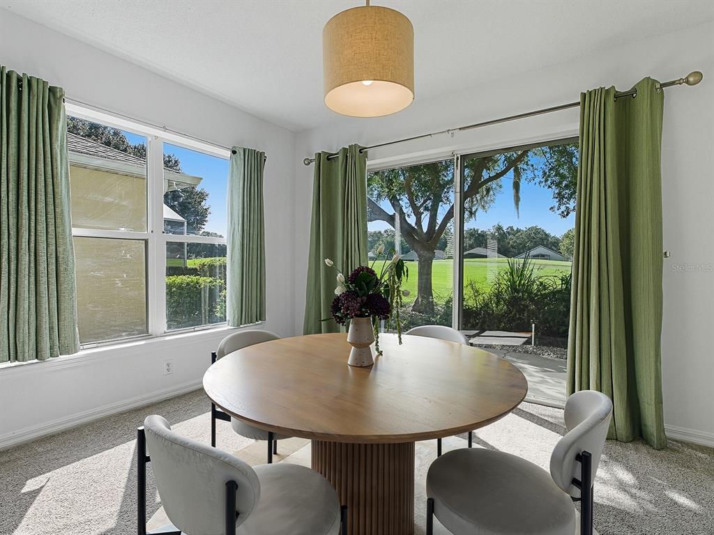 3016 Andover Court Mount Dora, FL 32757 - Photo 15 of 71 a view of a dining room with furniture window and outside view