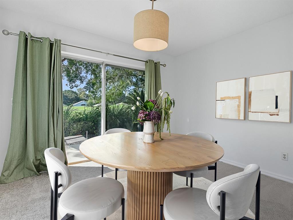 3016 Andover Court Mount Dora, FL 32757 - Photo 17 of 71 a view of a dining room with furniture and a window