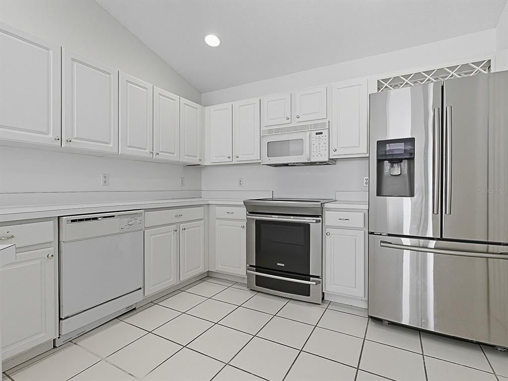 3016 Andover Court Mount Dora, FL 32757 - Photo 20 of 71 a kitchen with cabinets stainless steel appliances and a counter space