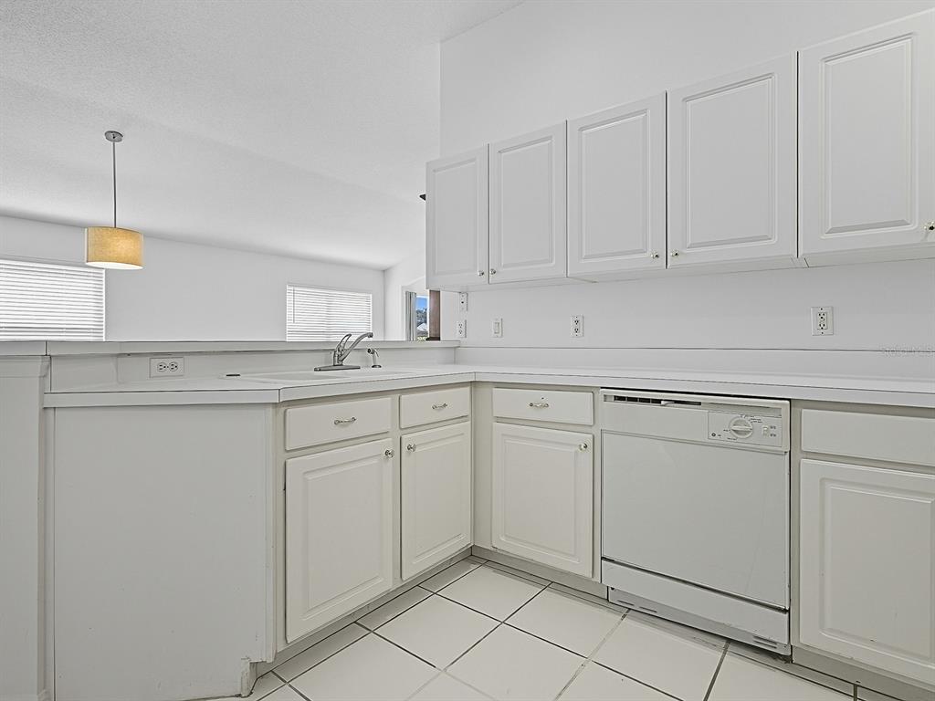 3016 Andover Court Mount Dora, FL 32757 - Photo 40 of 71 a kitchen with white cabinets and white appliances
