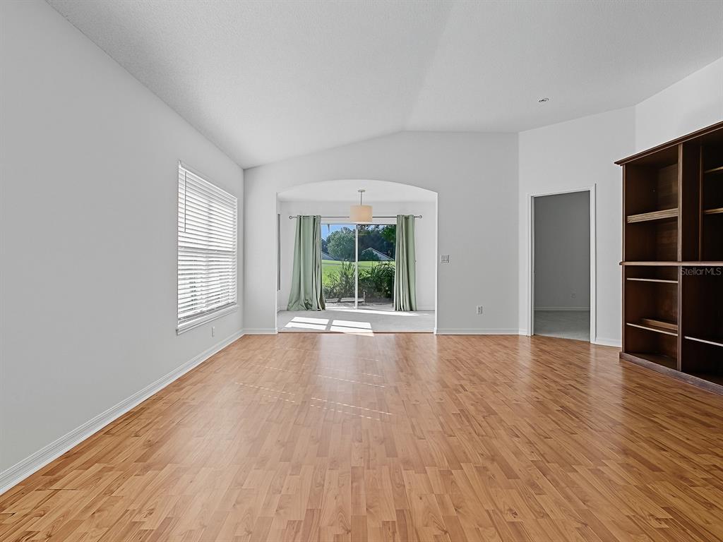 3016 Andover Court Mount Dora, FL 32757 - Photo 8 of 71 a view of an empty room with wooden floor and windows
