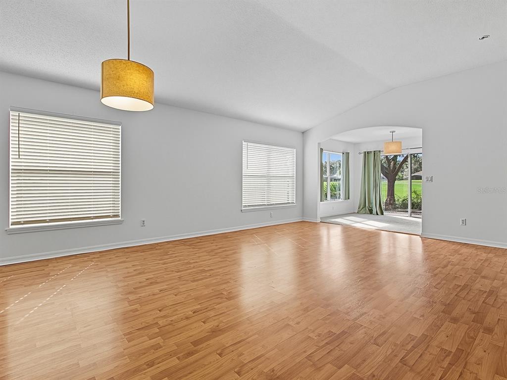 3016 Andover Court Mount Dora, FL 32757 - Photo 10 of 71 a view of an empty room with window and wooden floor