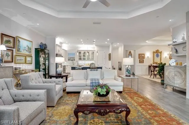 a living room with furniture wooden floor and a chandelier