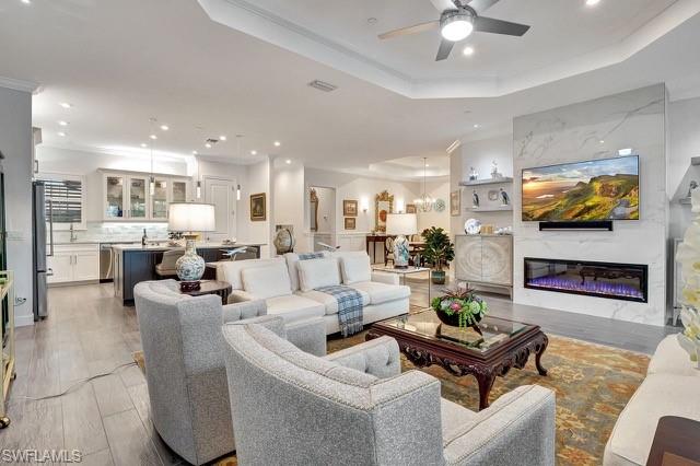 9637 Montelanico Loop, Unit 203 Naples, FL 34119 - Photo 14 of 50 View of remote electric linear fireplace, kitchen, and dining room area.