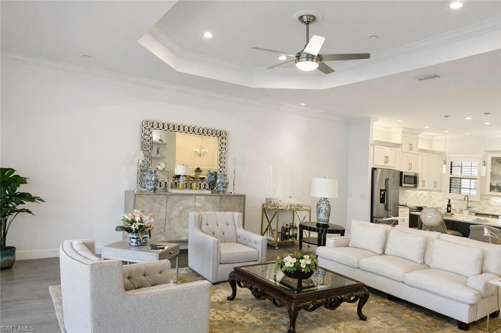 9637 Montelanico Loop, Unit 203 Naples, FL 34119 - Photo 19 of 50 Featuring crown molding, porcelain wood-like finished floors, tray ceiling with recessed lighting, and ceiling fan