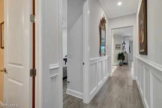 a view of a hallway with wooden floor