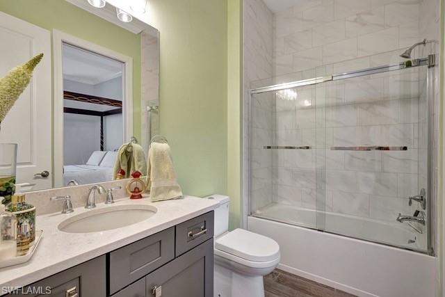 9637 Montelanico Loop, Unit 203 Naples, FL 34119 - Photo 27 of 50 Original color of full bathroom before being painted, featuring glass shower enclosure, with guest bedroom adjacent