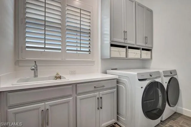 a utility room with cabinets dryer and washer