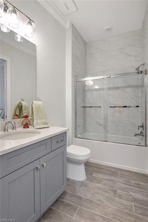 9637 Montelanico Loop, Unit 203 Naples, FL 34119 - Photo 28 of 50 Recently painted walls, full bath with enclosed glass shower / bath combination vanity, porcelain wood-like tiled floors, and vanity
