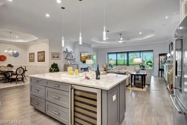 a kitchen with a sink stainless steel appliances and view living room