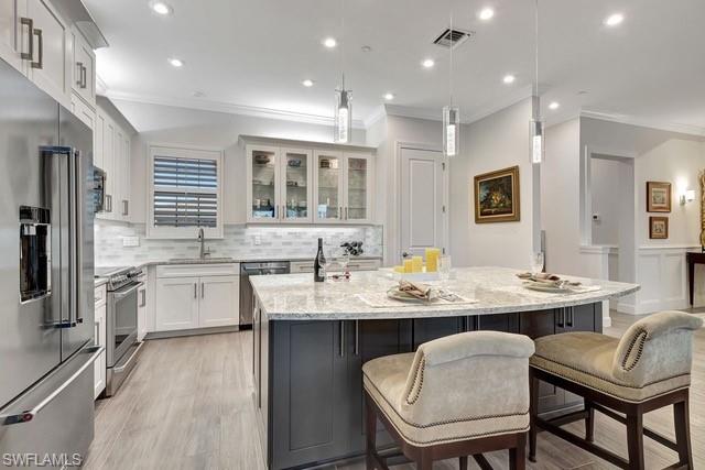 9637 Montelanico Loop, Unit 203 Naples, FL 34119 - Photo 7 of 50 Showing glass cabinets and stainless steel appliances