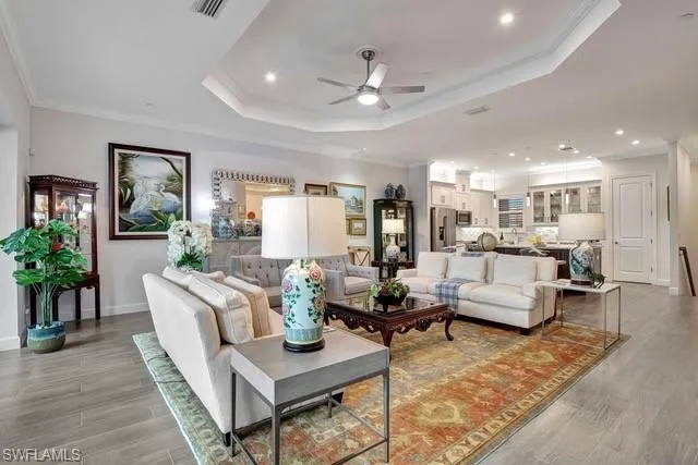a living room with furniture and view of kitchen