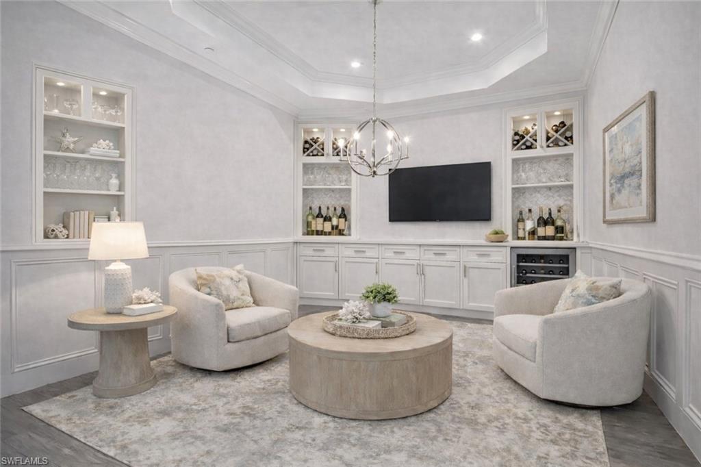 9637 Montelanico Loop, Unit 203 Naples, FL 34119 - Photo 10 of 50 Virtually staged TV/Wine /Dining/Flex Room with beverage cooler, built-in-shelving. Custom Millwork, tray ceiling, crown moulding, and new lighting fixture