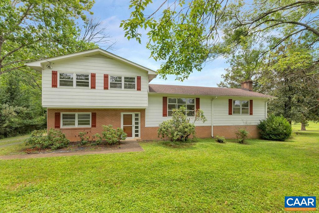 3605 Keswick Road Keswick, VA 22947 - Photo 1 of 35 a front view of a house with a garden and yard