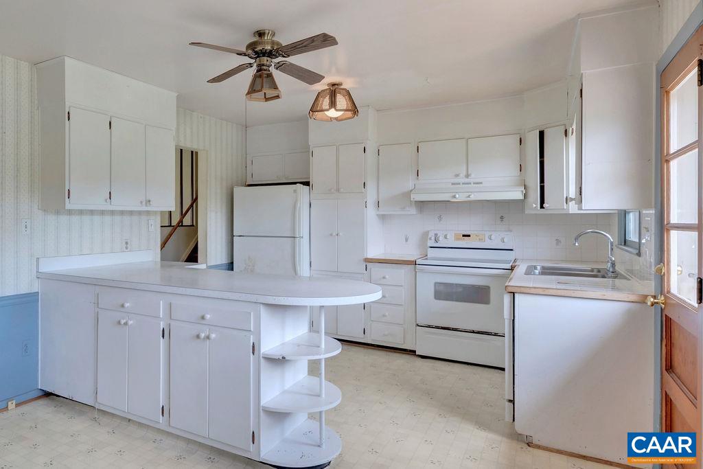 3605 Keswick Road Keswick, VA 22947 - Photo 17 of 35 a kitchen with white cabinets and white appliances
