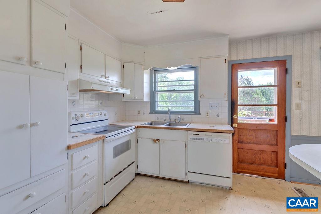 3605 Keswick Road Keswick, VA 22947 - Photo 20 of 35 a kitchen with white cabinets appliances a sink and a window