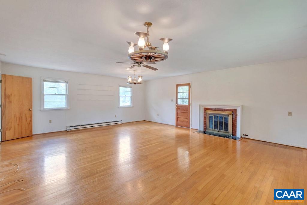 3605 Keswick Road Keswick, VA 22947 - Photo 23 of 35 a view of an empty room with wooden floor and a window