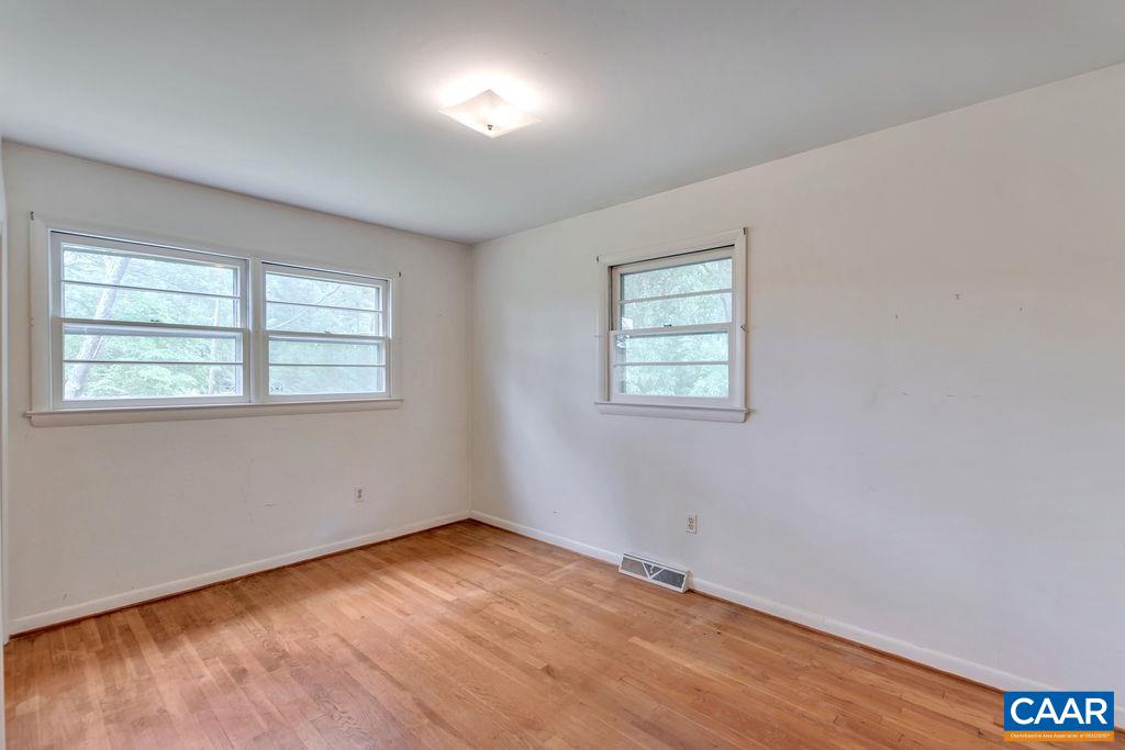 3605 Keswick Road Keswick, VA 22947 - Photo 29 of 35 an empty room with wooden floor and windows