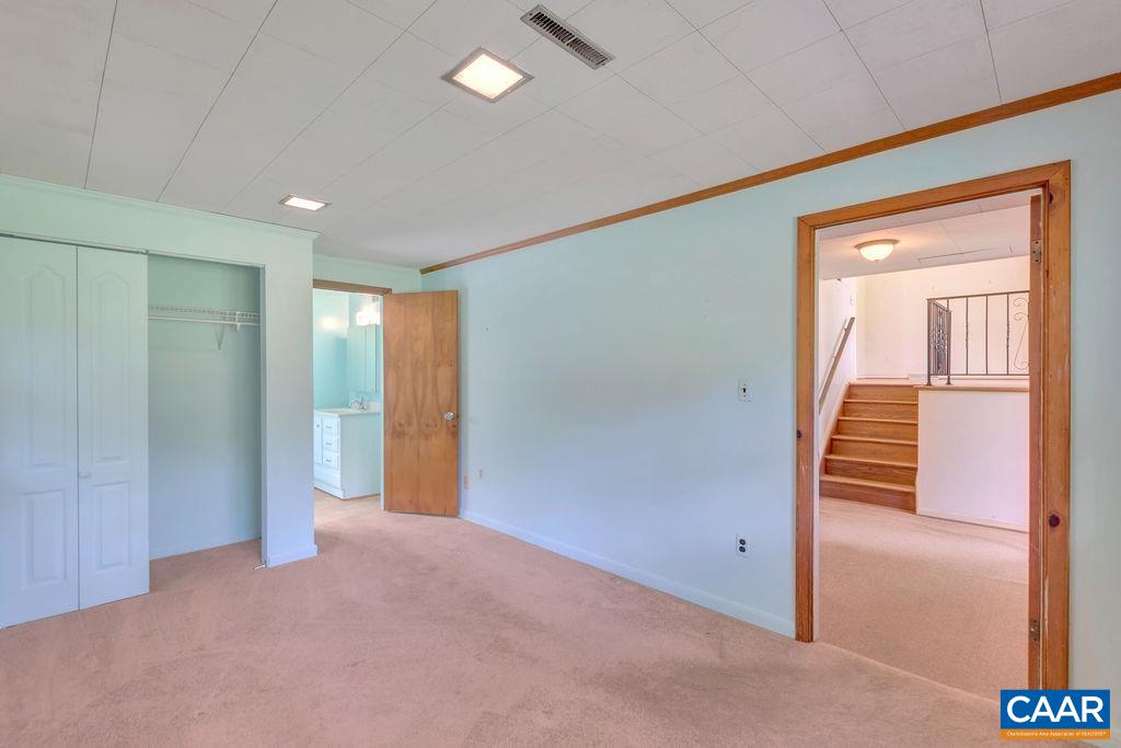 3605 Keswick Road Keswick, VA 22947 - Photo 8 of 35 an empty room with wooden floor and mirror