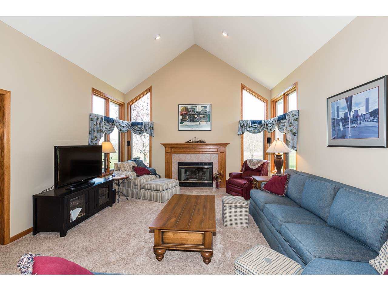 8761 Goeke Road Davis, IL 61019 - Photo 3 of 21 a living room with furniture a flat screen tv and a fireplace
