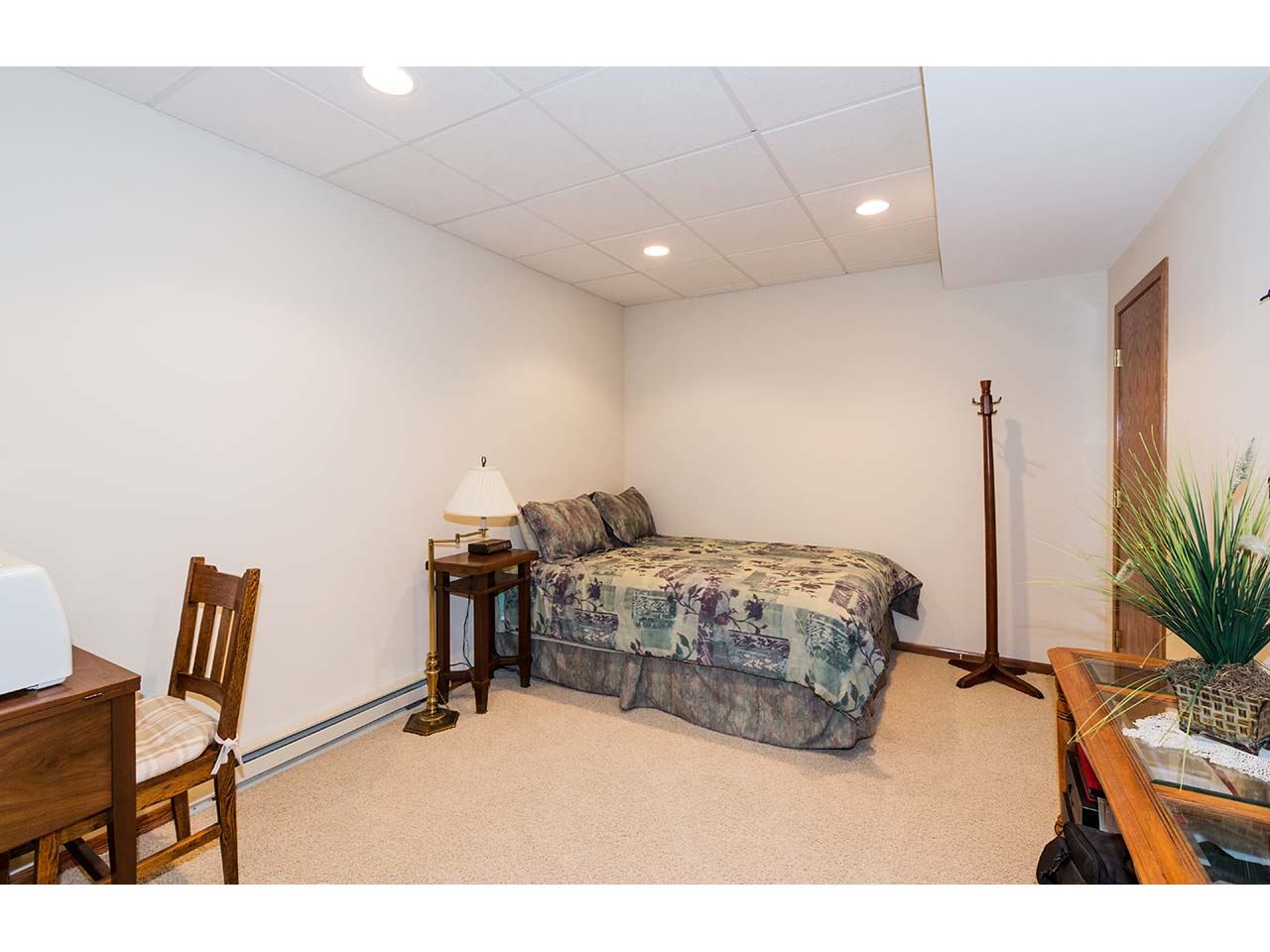 8761 Goeke Road Davis, IL 61019 - Photo 8 of 21 a bedroom with a bed and a chair with the wooden floor