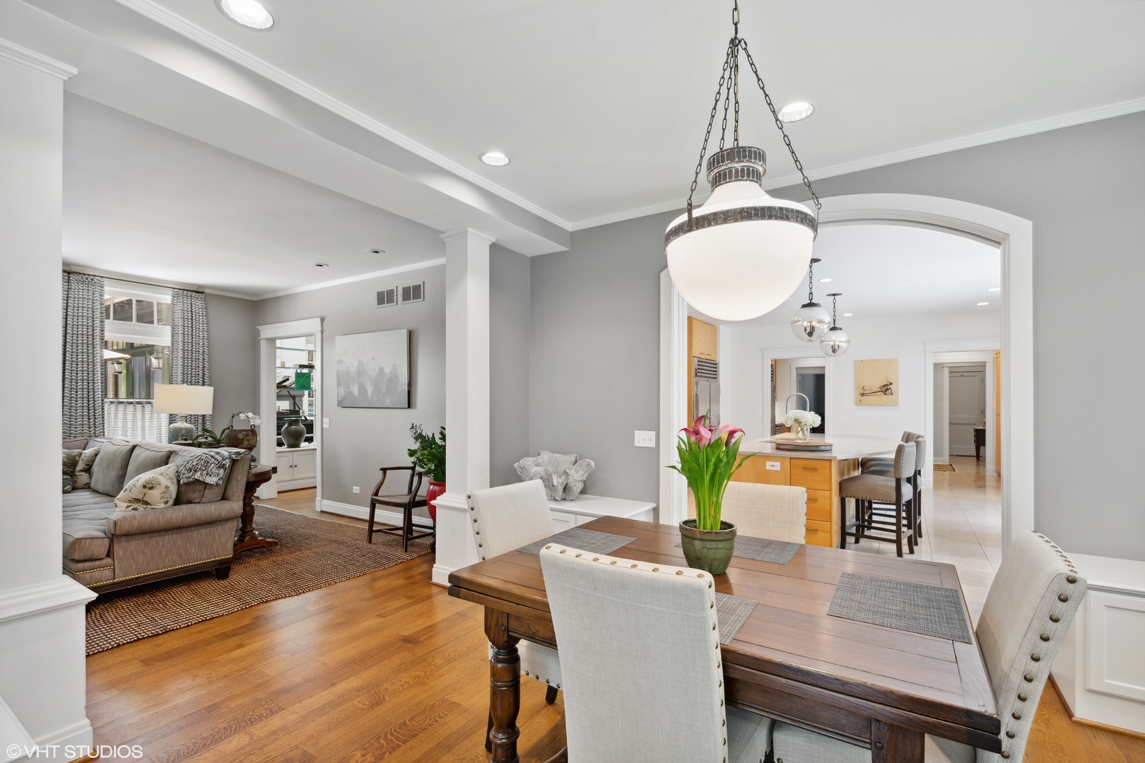 520 Forest Cove Road Lake Bluff, IL 60044 - Photo 11 of 48 a living room with furniture dining table a chandelier a mirror and a dining table with wooden floor