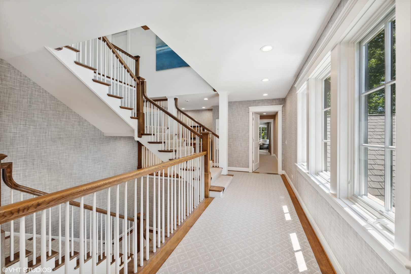 520 Forest Cove Road Lake Bluff, IL 60044 - Photo 18 of 48 a view of staircase with lots of frames on wall and windows