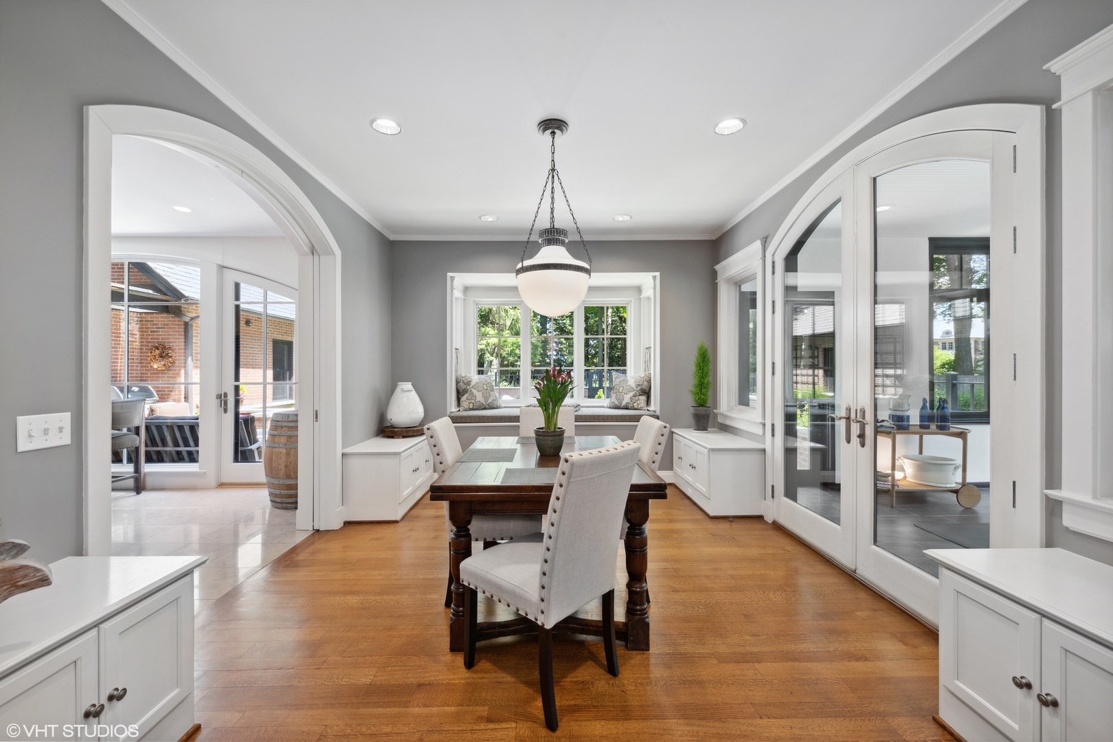 520 Forest Cove Road Lake Bluff, IL 60044 - Photo 9 of 48 a dining room with wooden floor and large windows