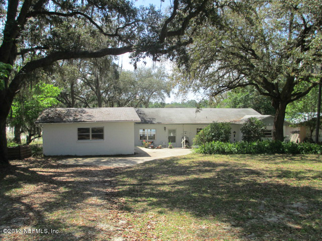 6444 Brooklyn Bay Road Keystone Heights, FL 32656 - Photo 18 of 32 a view of a house with a yard and tree
