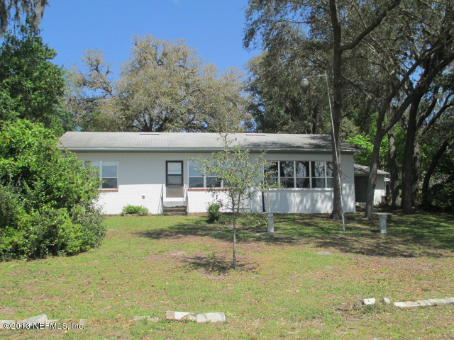 6444 Brooklyn Bay Road Keystone Heights, FL 32656 - Photo 24 of 32 a view of a house with a yard porch and sitting area