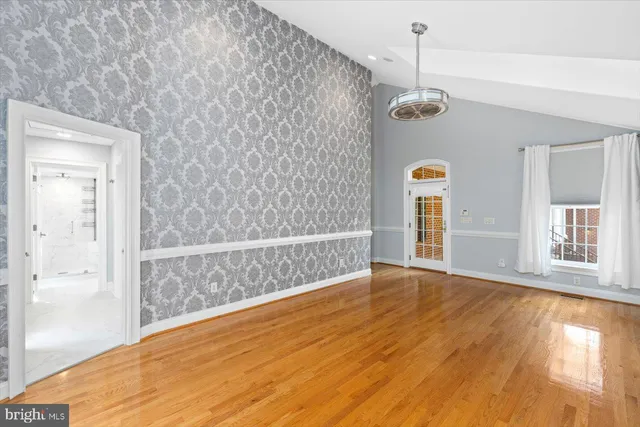 a view of an empty room and a window