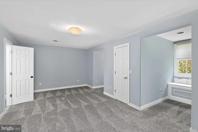 a view of a room with furniture and windows